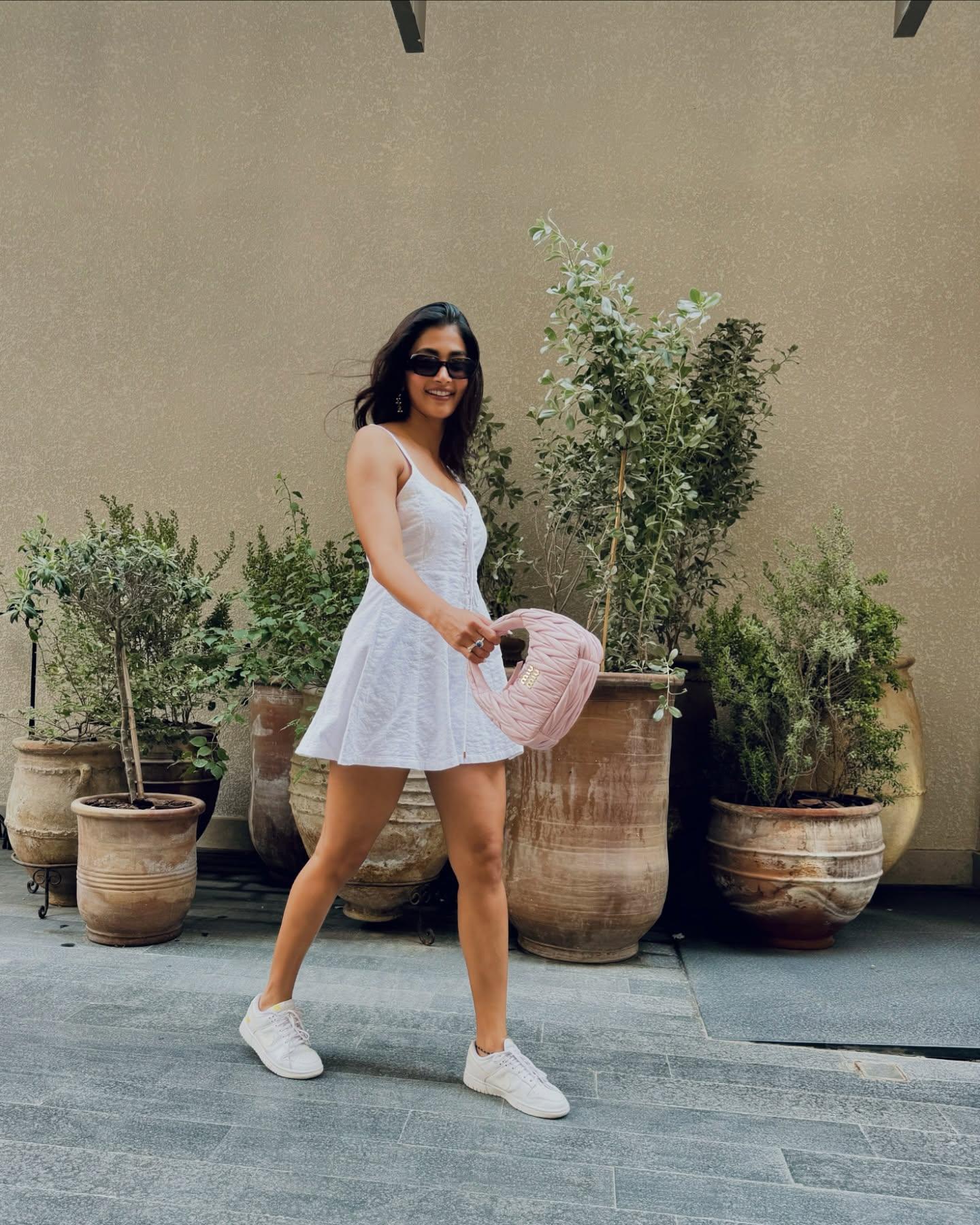 Pooja Hegde Wearing White Dress Outdoors in Sunlight Image