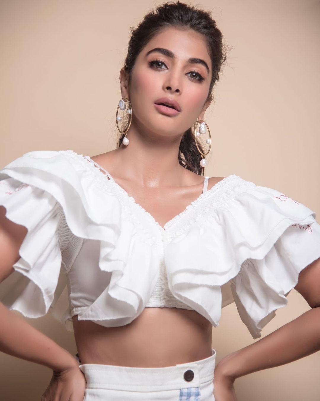 White Ruffle Outfit Look of Pooja Hegde in Studio Setting