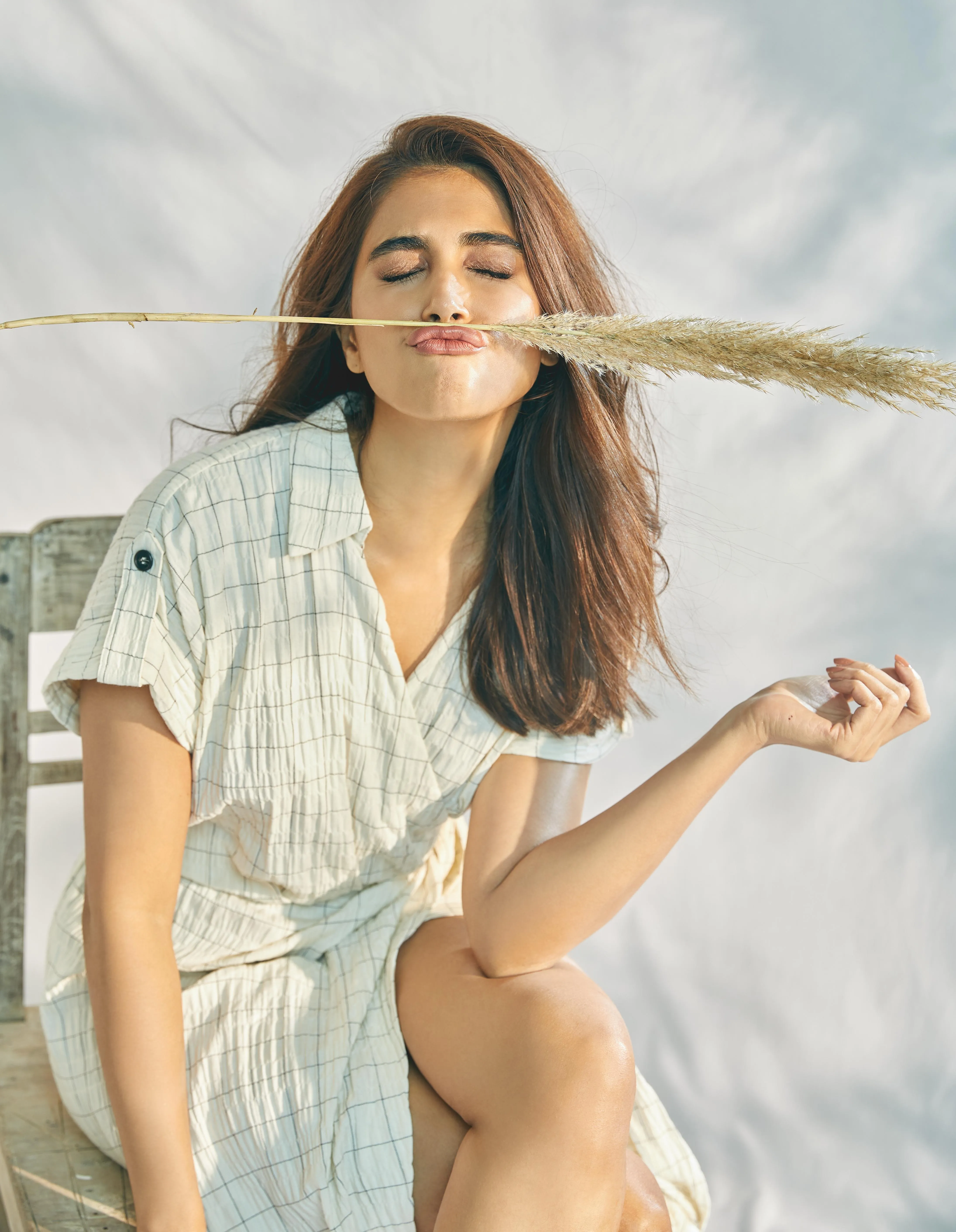 Breezy Look of Pooja Hegde with Closed Eyes and Reed Stem