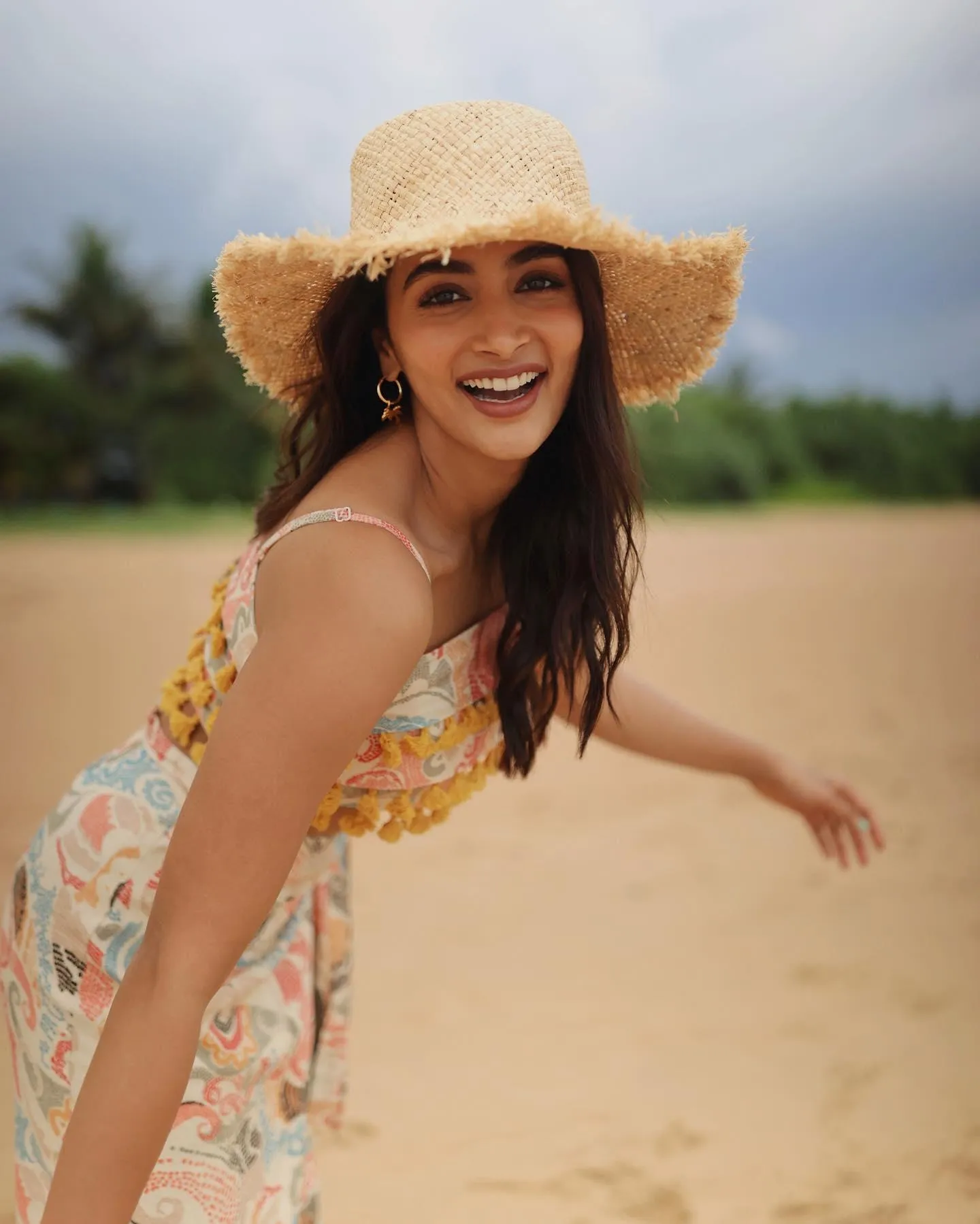Cheerful Pooja Hegde Smiling in Floral Dress with Sun Hat