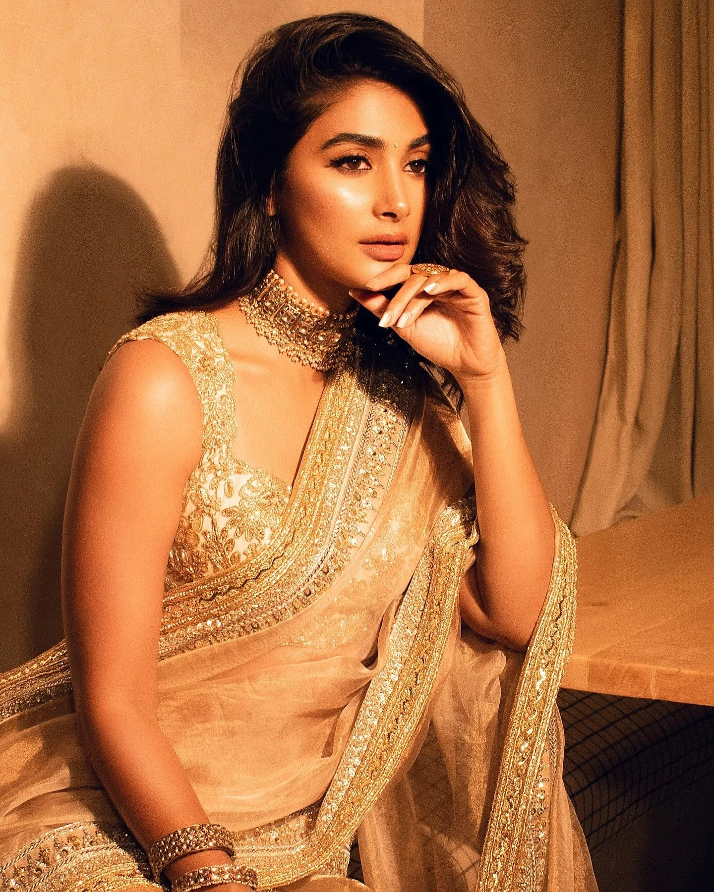 Elegant Pooja Hegde in Golden Saree Looking Thoughtfully