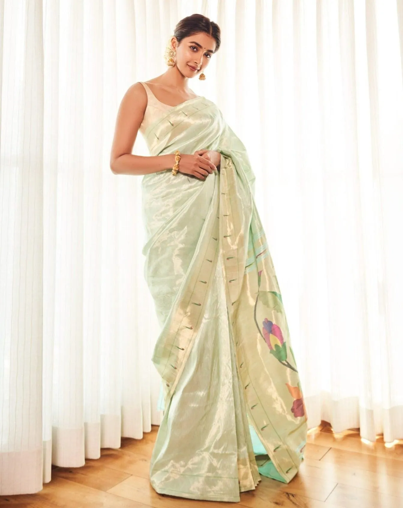 Elegant Pooja Hegde Posing in a Light Green Saree Wallpaper