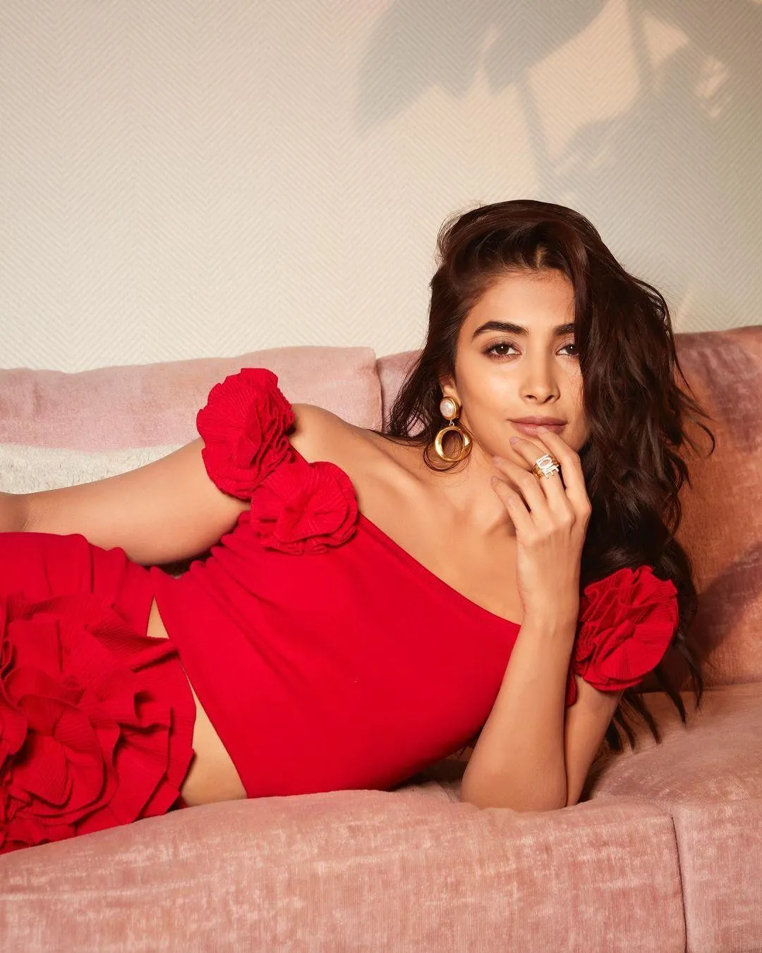 Elegant Pooja Hegde Relaxing in Bright Red Dress Image