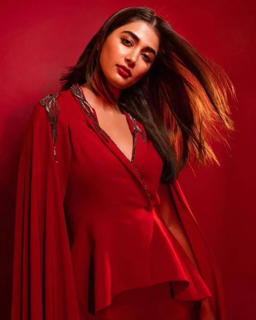 Fierce Look of Pooja in Bold Red Ensemble on Red Background