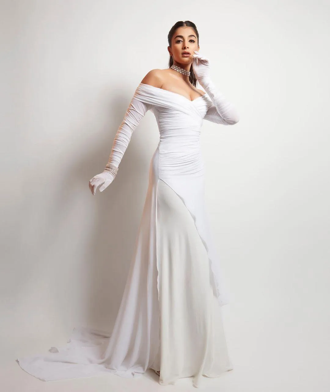 Glamorous Pose By Pooja Hegde in Full Length White Gown