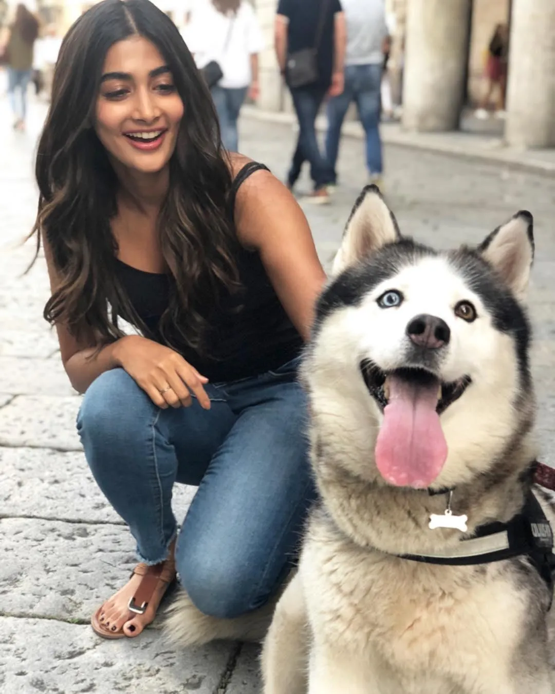 Joyful Pooja Hegde Posing Outdoors with Happy Dog