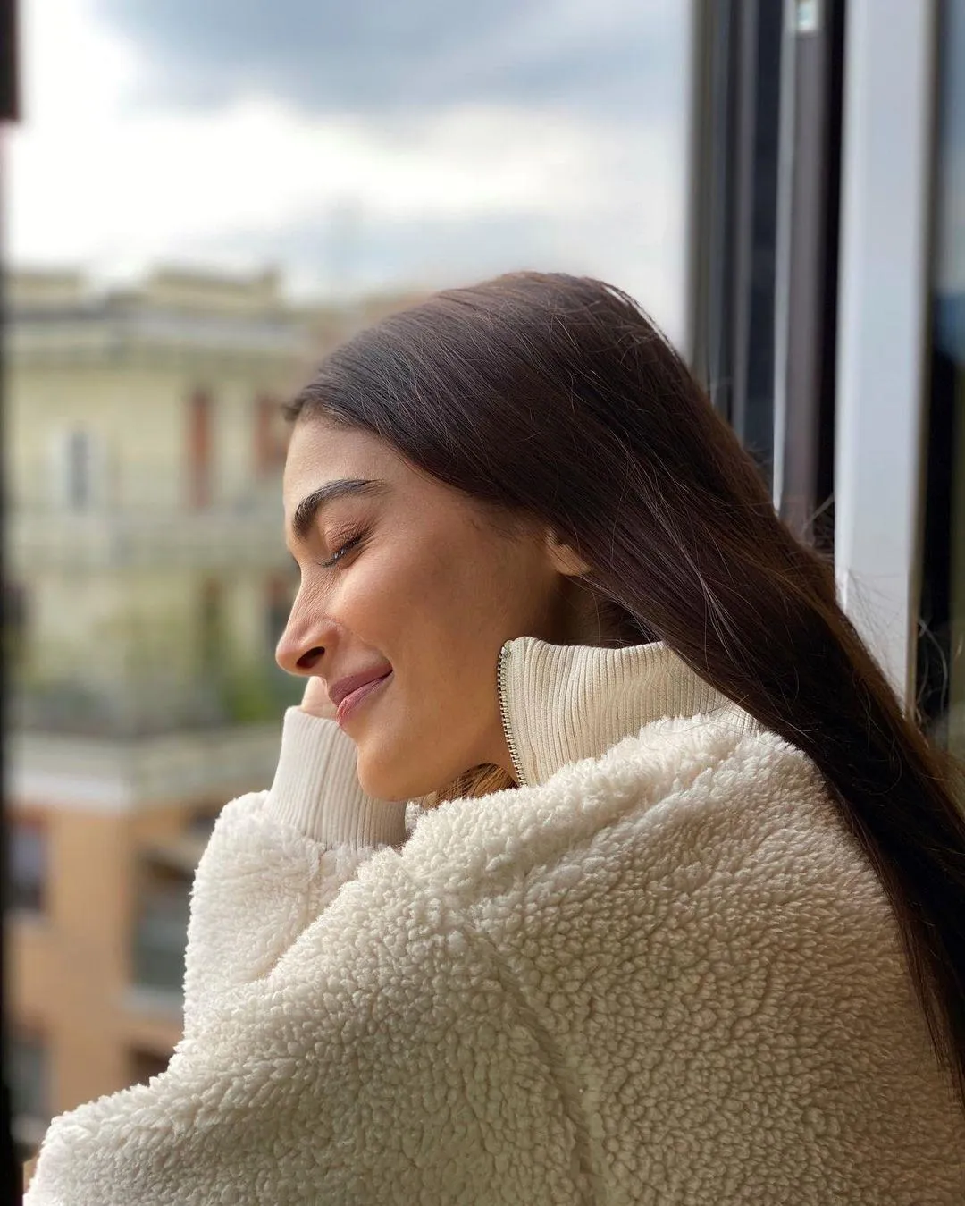 Peaceful Pooja Hegde Leaning By Window in Cozy Sweater