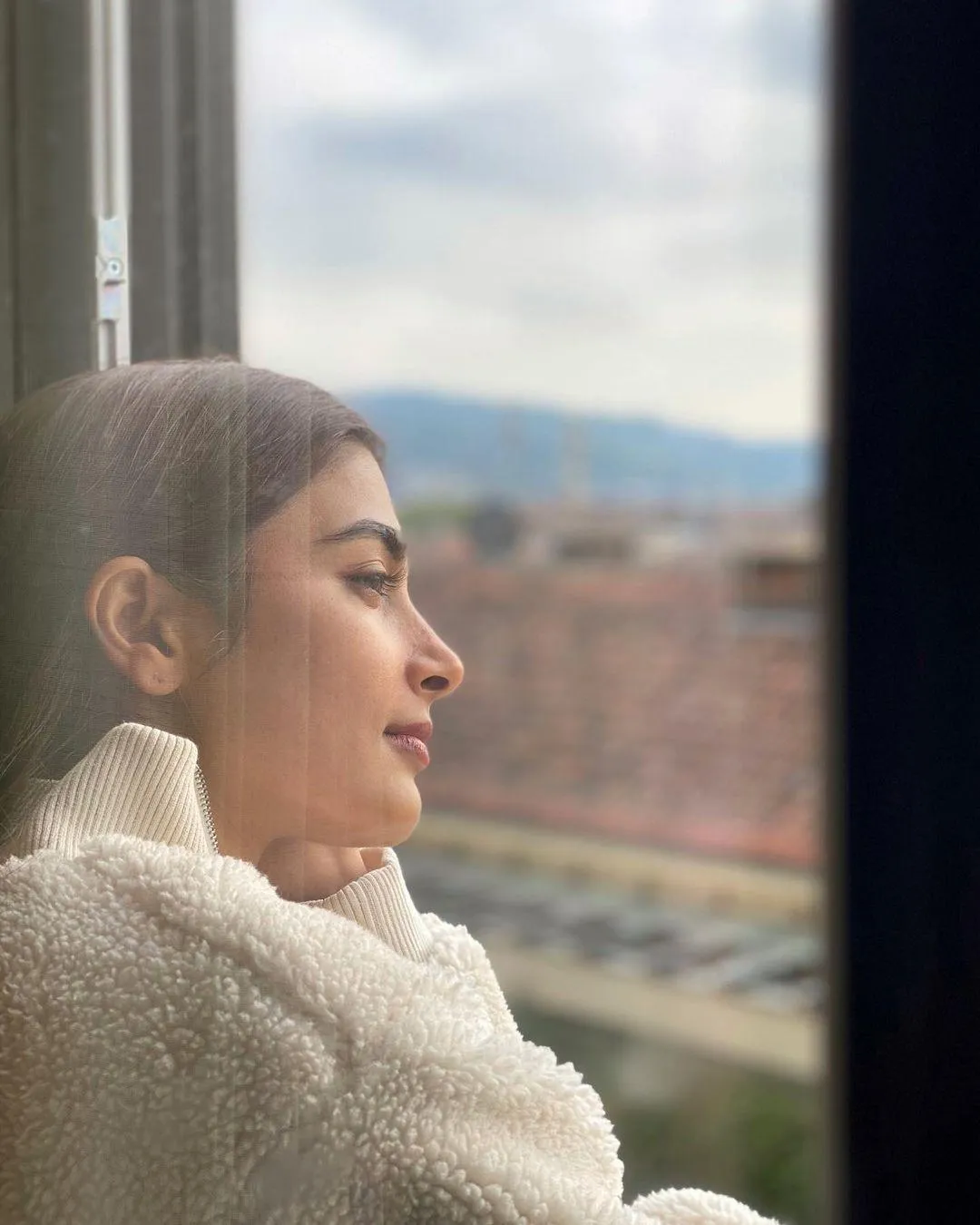 Pooja Hegde Gazing Out Window in Cream Sweater Wallpaper