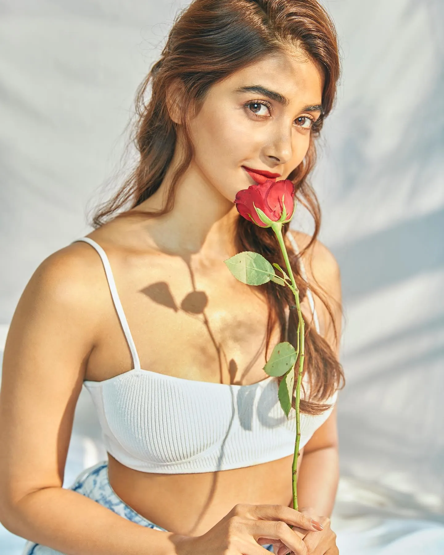 Pooja Hegde Holding a Rose Wearing White Top Wallpaper