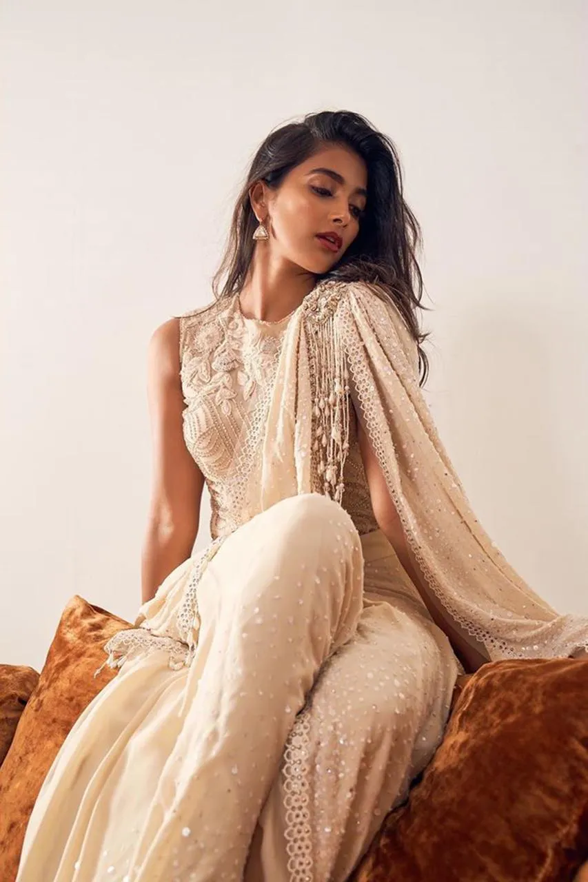 Pooja Hegde in Beige Designer Gown Sitting Gracefully