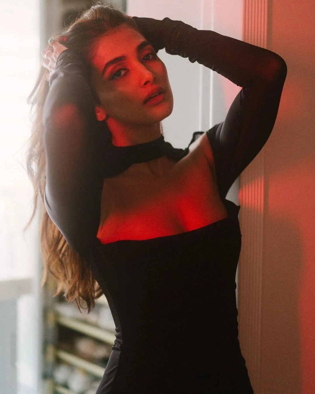 Pooja Hegde in Black Dress with Dramatic Red Lighting