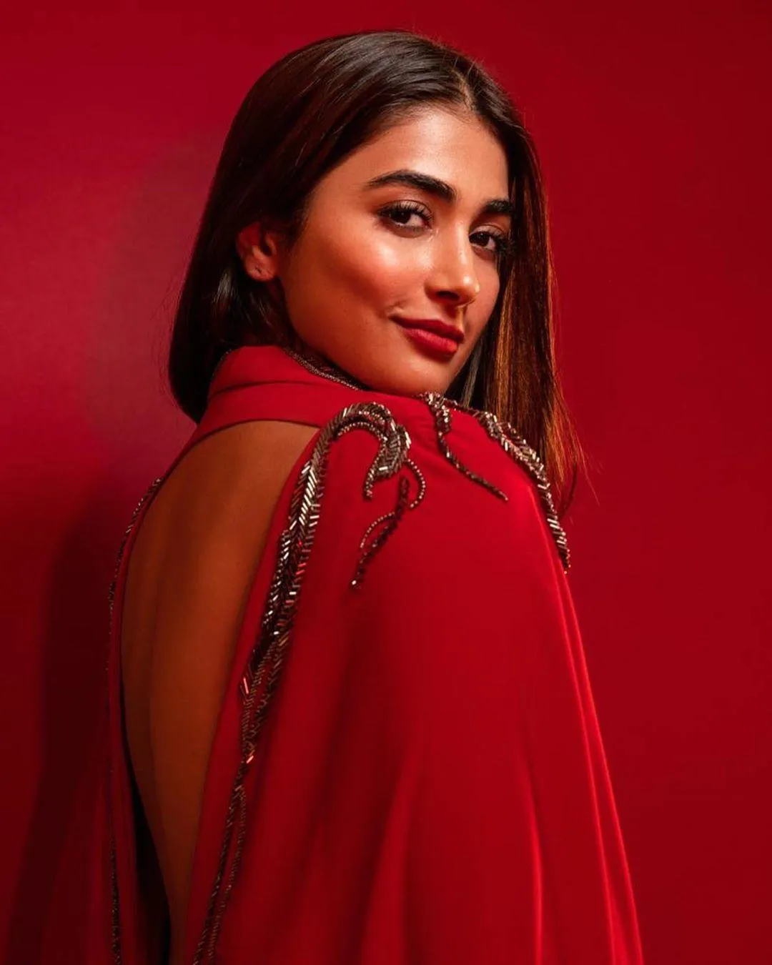 Pooja Hegde in Bold Red Outfit with Confident Overlook Pose