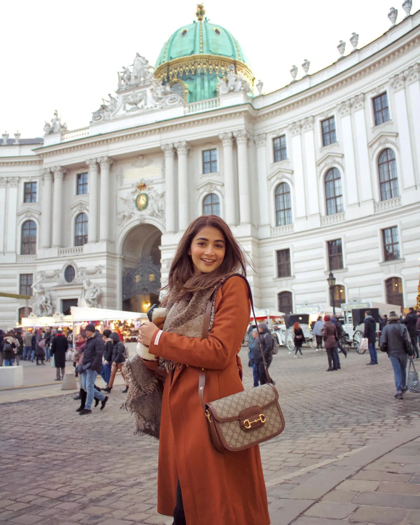 Pooja Hegde in Brown Coat Posing in European City Square