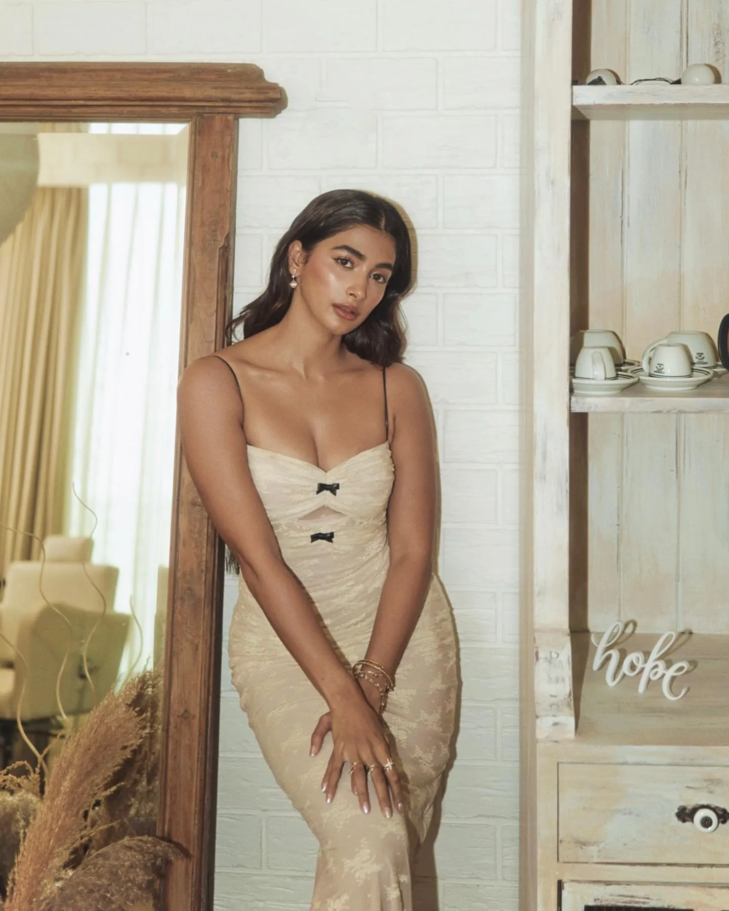 Pooja Hegde in Casual Beige Dress By a Wooden Shelf