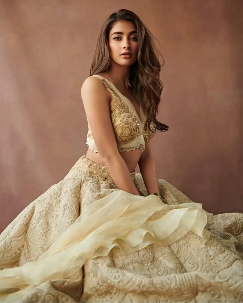 Pooja Hegde in Designer Beige Gown Sitting Gracefully Indoors