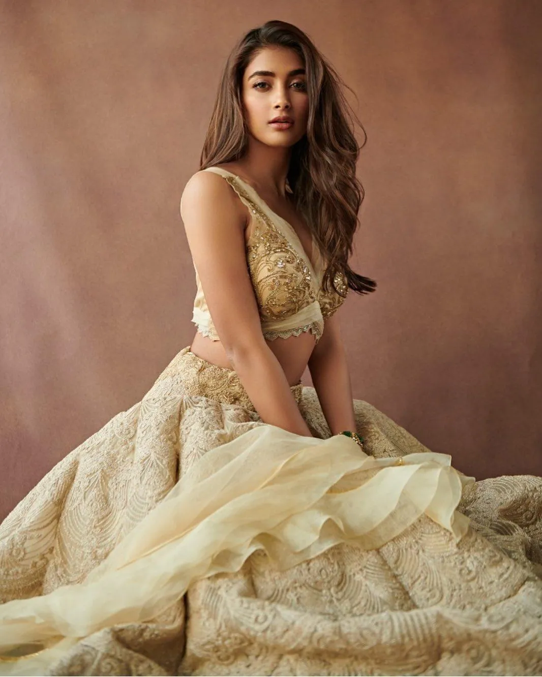 Pooja Hegde in Elegant Cream Gown Posing on the Floor