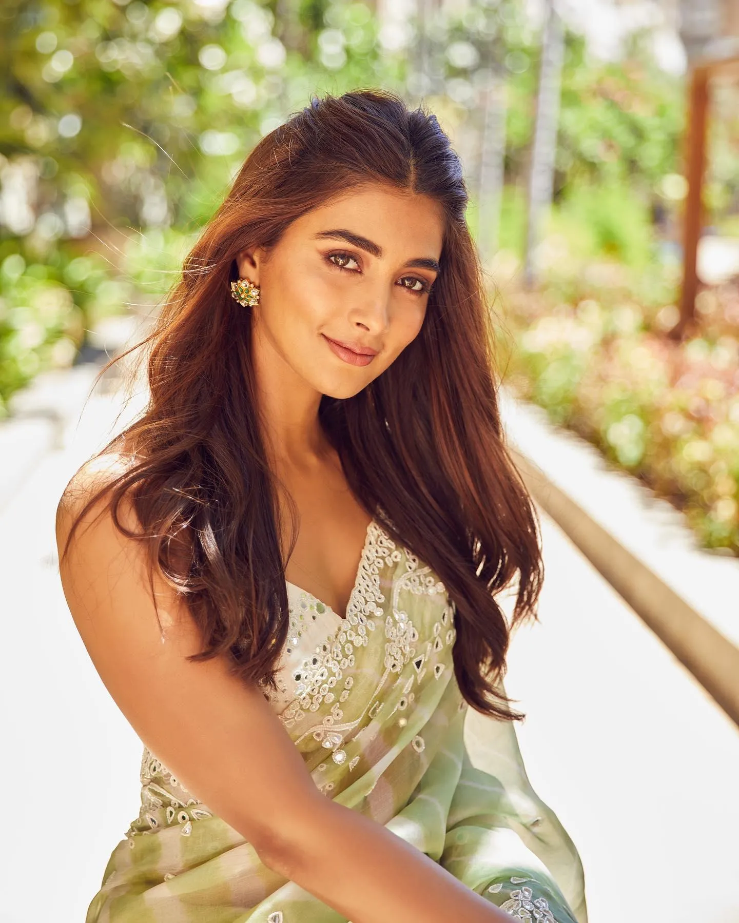 Pooja Hegde in Elegant Light Green Outfit Sitting Outdoors