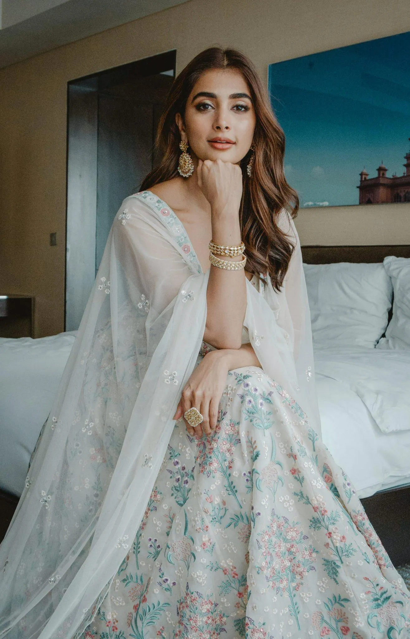 Pooja Hegde in Floral Lehenga Sitting on Hotel Bed Wallpaper