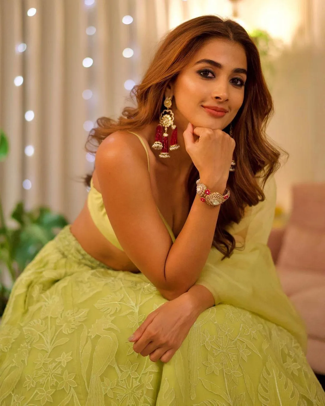 Pooja Hegde in Green Gown Smiling with Hand on Chin Image