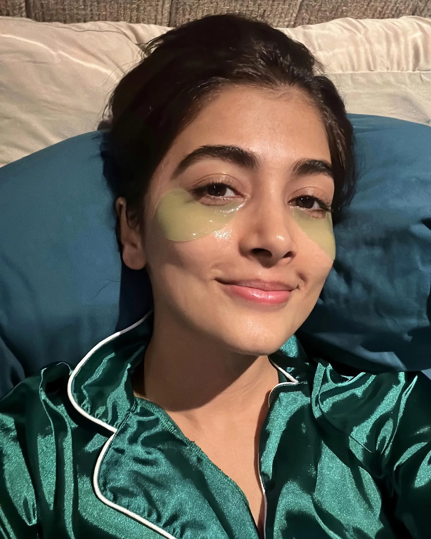 Pooja Hegde in Green Satin Nightwear Lying on Bed Wallpaper