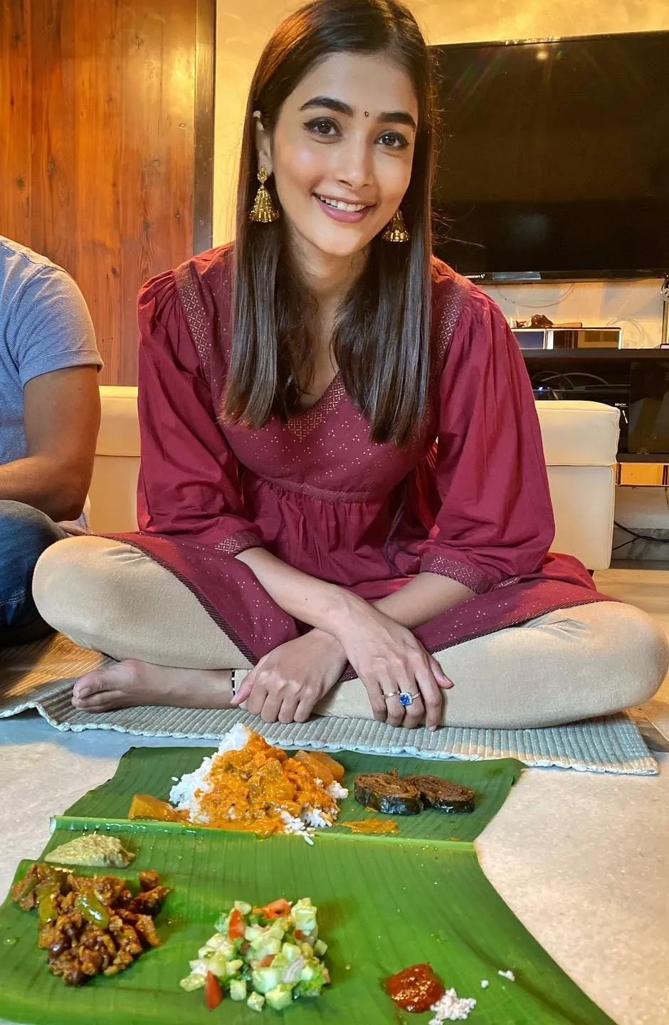 Pooja Hegde in Maroon Outfit Sitting with Traditional Meal