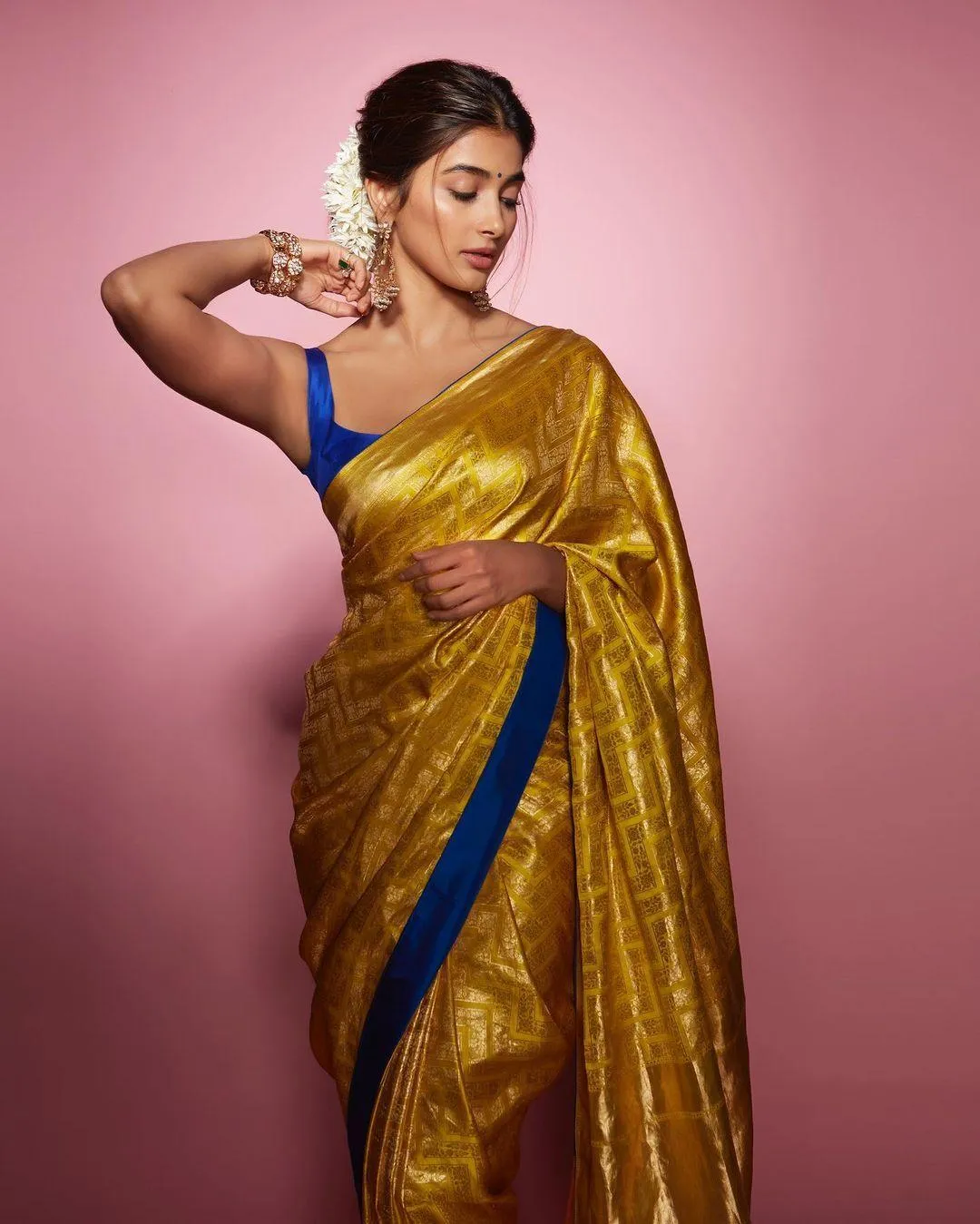 Pooja Hegde in Mustard Saree with Bold Blue Blouse Pose