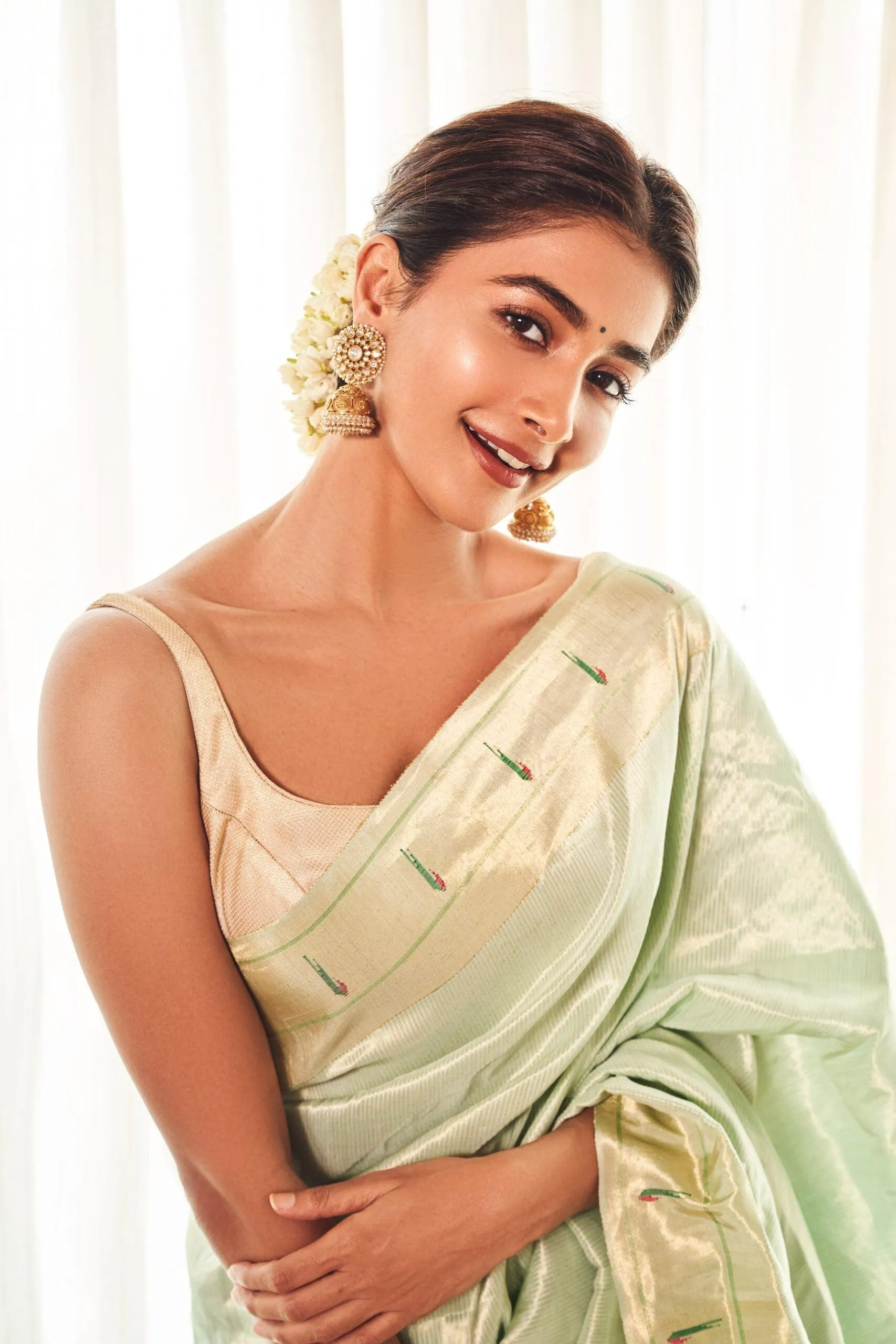 Pooja Hegde in Pastel Green Saree with Elegant Bun
