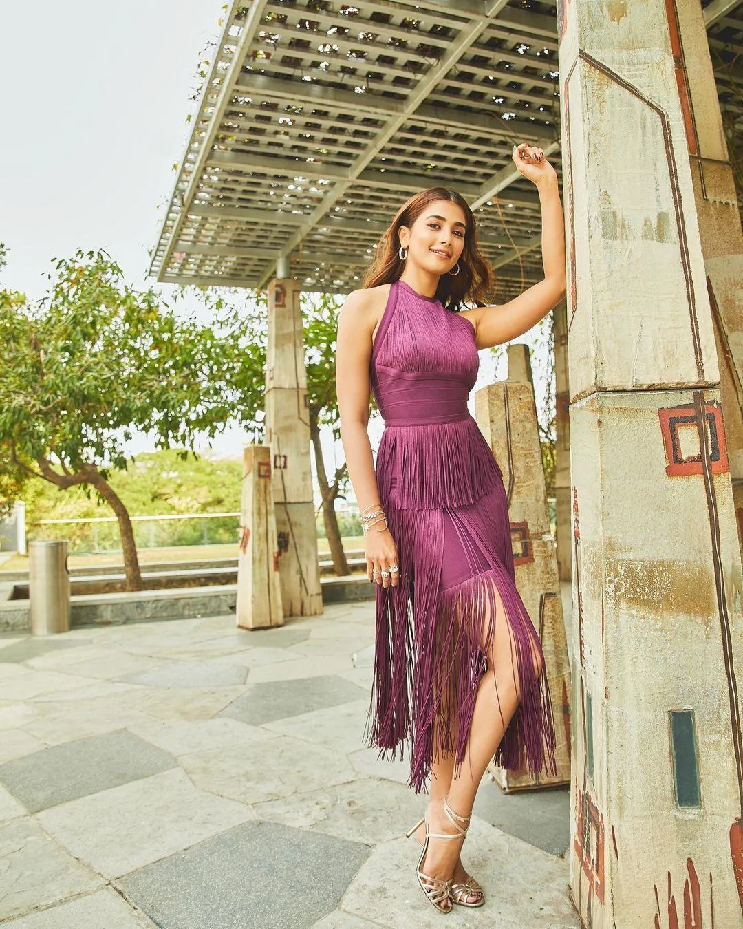 Pooja Hegde in Purple Dress Posing By Wooden Pillar Wallpaper