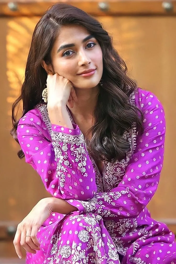 Pooja Hegde in Purple Outfit Smiling with Hand on Face