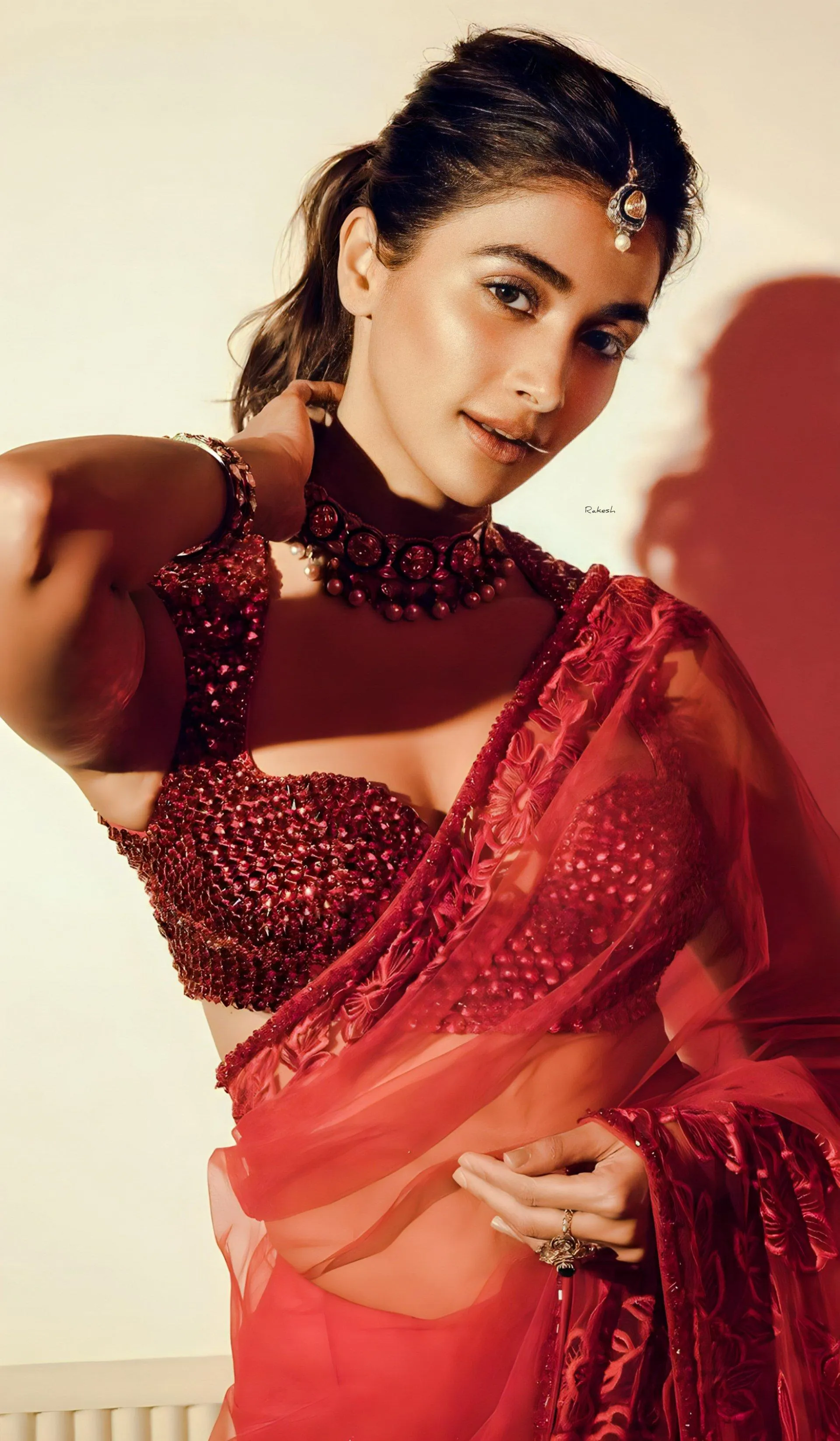 Pooja Hegde in Red Saree with Dramatic Pose Against Red Shadow
