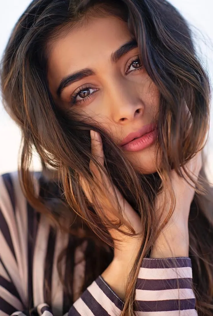 Pooja Hegde in Striped Top with Hand Near Her Face Image