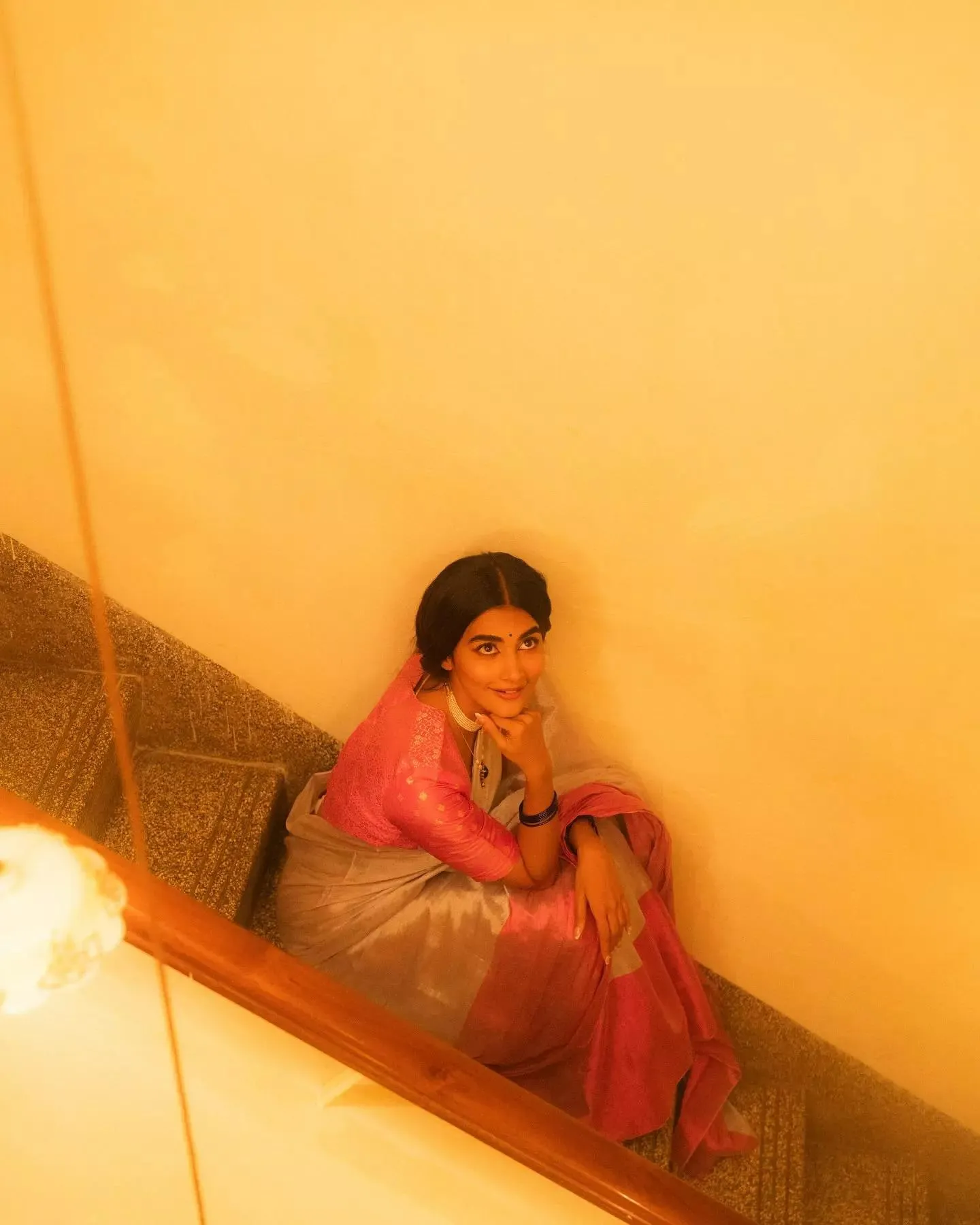 Pooja Hegde in Traditional Pink Attire Sitting on Stairs