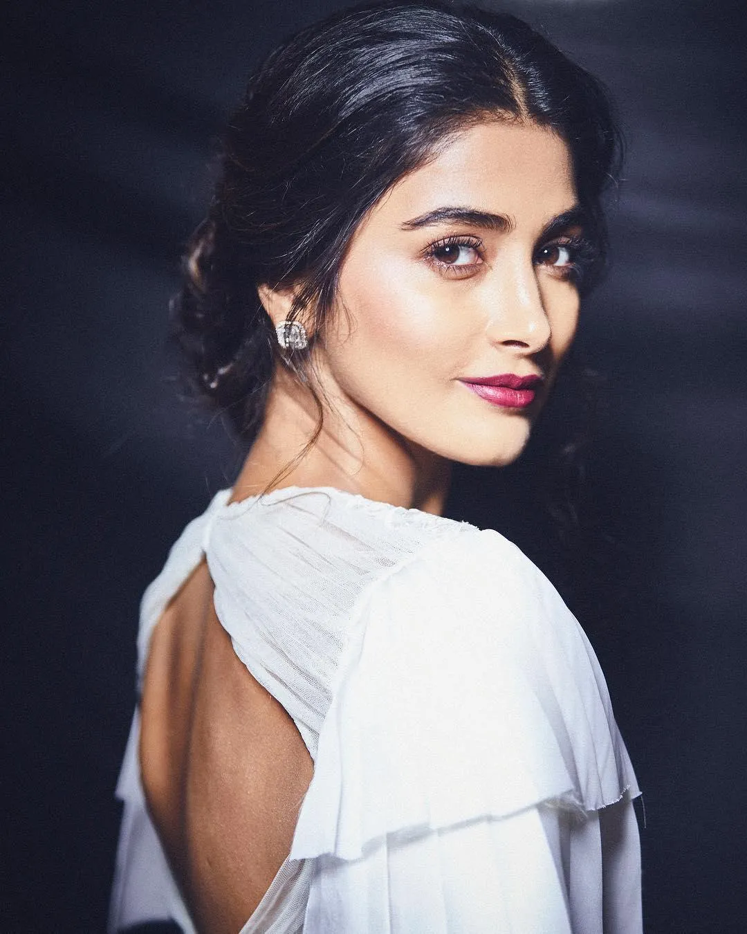 Pooja Hegde in White Dress Looking Over Shoulder Wallpaper