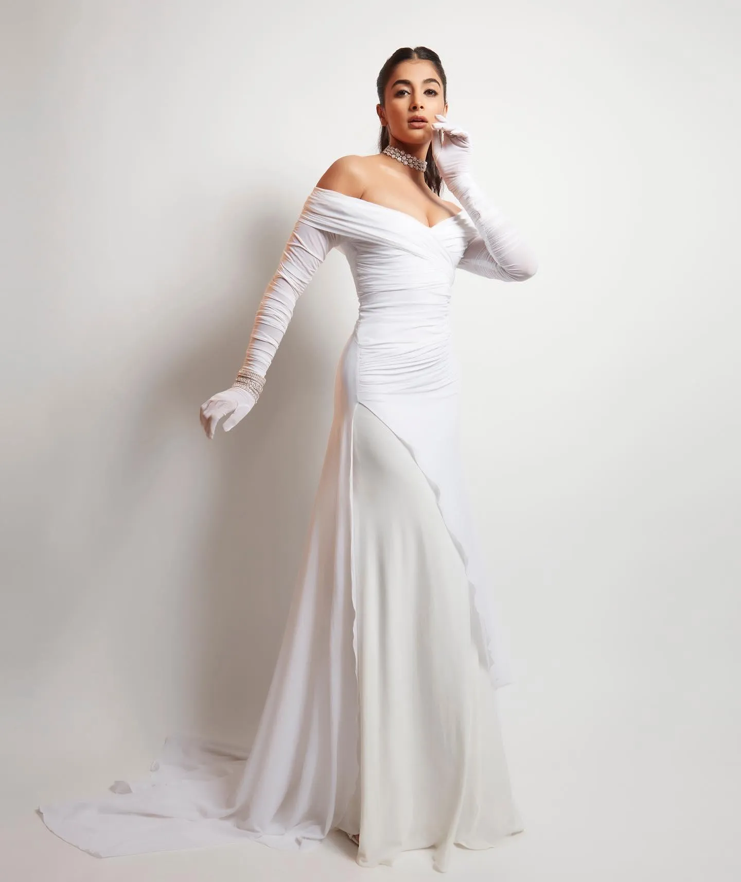 Pooja Hegde in White Gown with Long Gloves and Chic Pose
