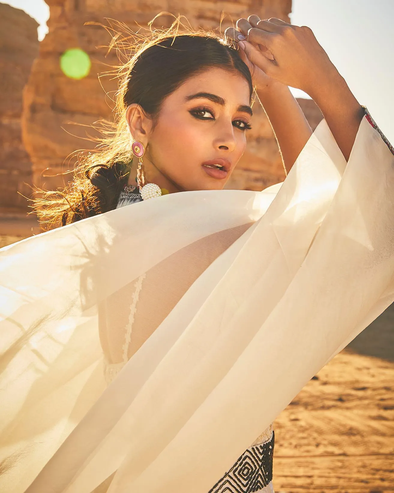 Pooja Hegde in White Outfit Posing in the Desert Breeze