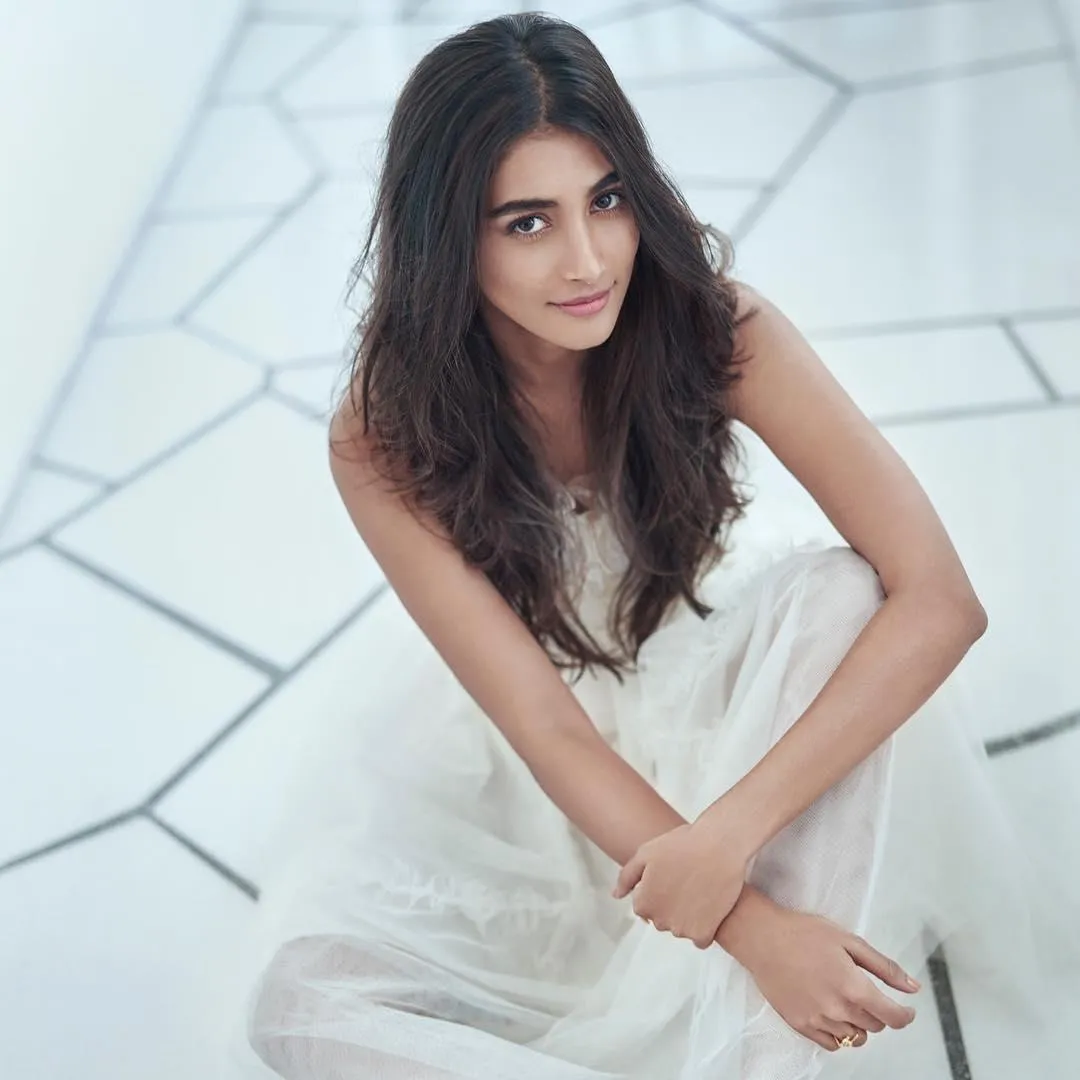 Pooja Hegde in White Outfit Sitting on Floor Elegantly