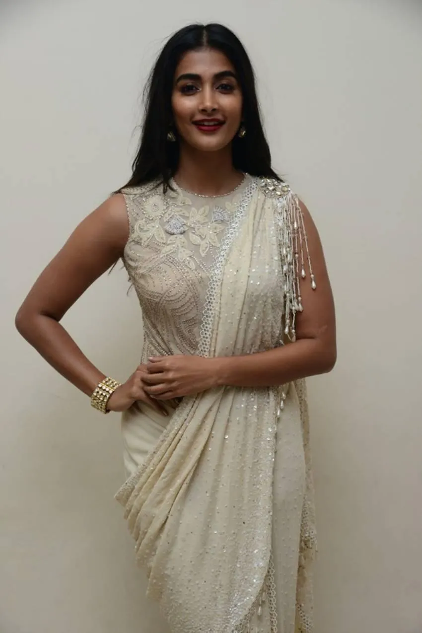 Pooja Hegde in White Saree Smiling with Poise and Grace