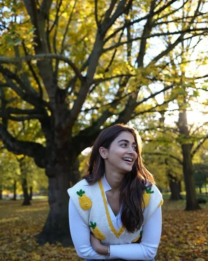 Pooja Hegde in White Sweater Posing in Autumn Background