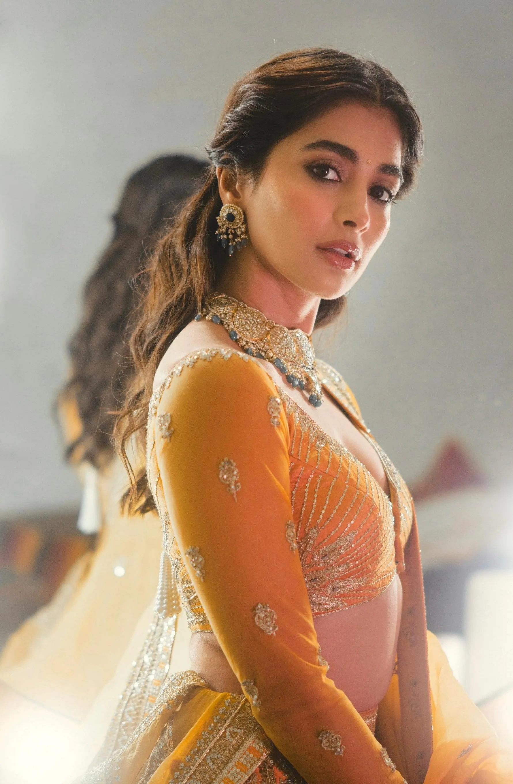 Pooja Hegde in Yellow and White Lehenga Turning Toward Camera