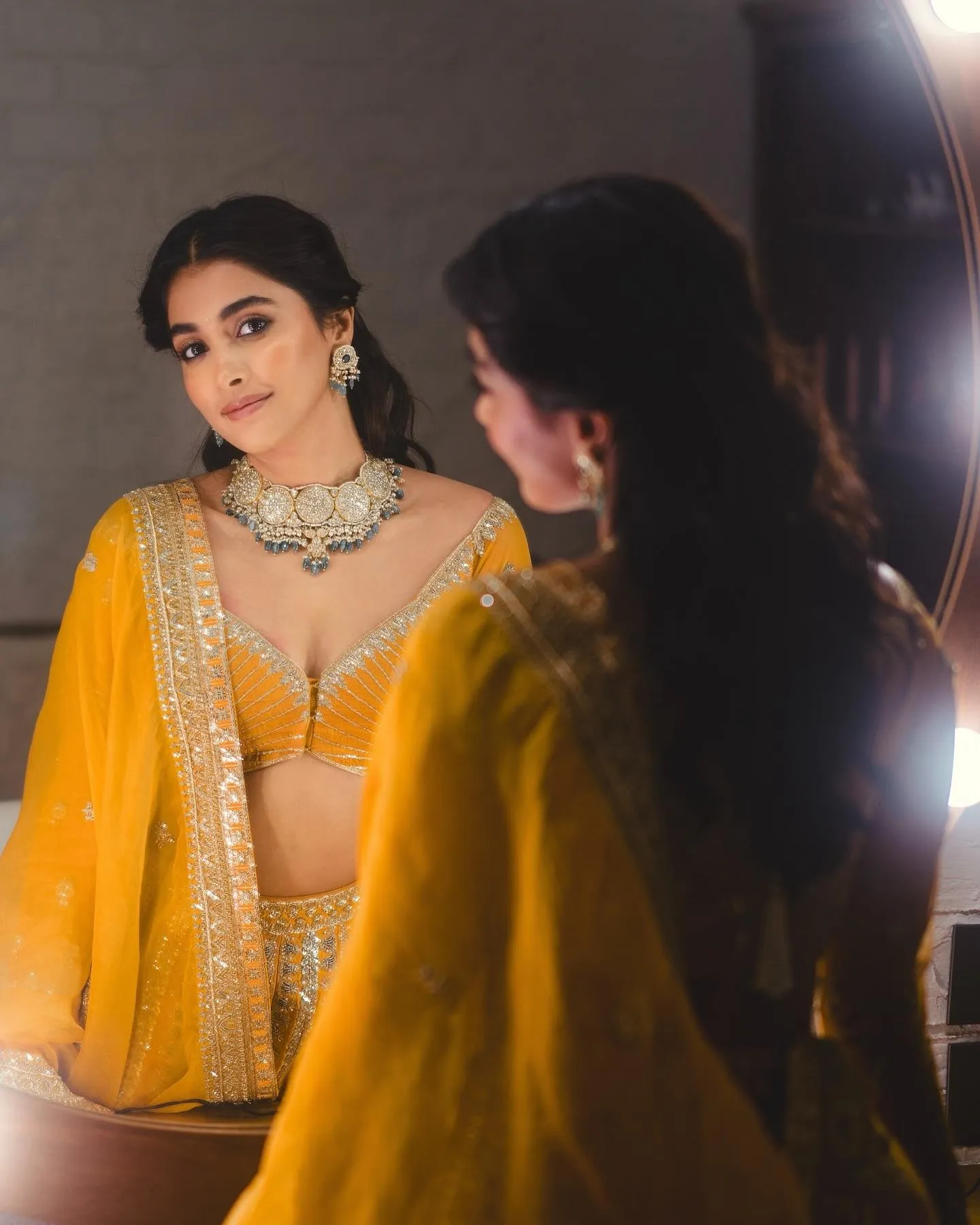 Pooja Hegde in Yellow Lehenga Admiring Her Reflection