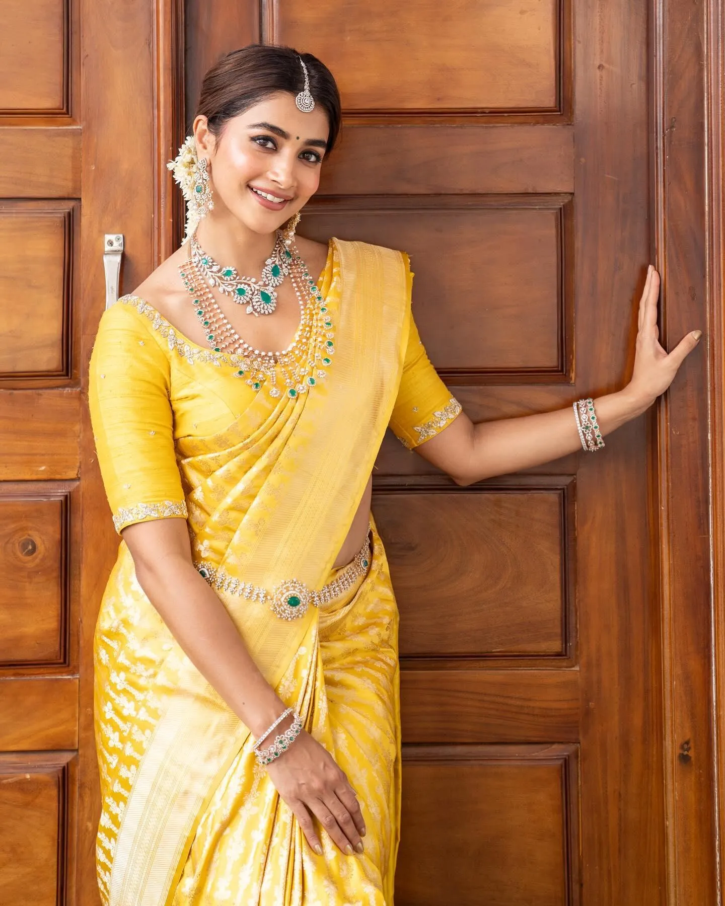 Pooja Hegde in Yellow Saree Posing By Wooden Door Wallpaper