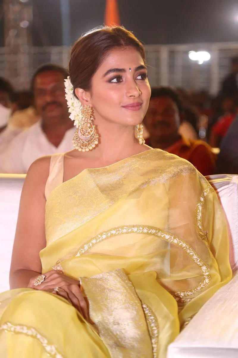 Pooja Hegde in Yellow Saree Sitting At Film Function