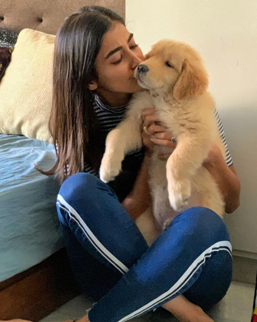 Pooja Hegde Kissing a Puppy While Sitting on Floor