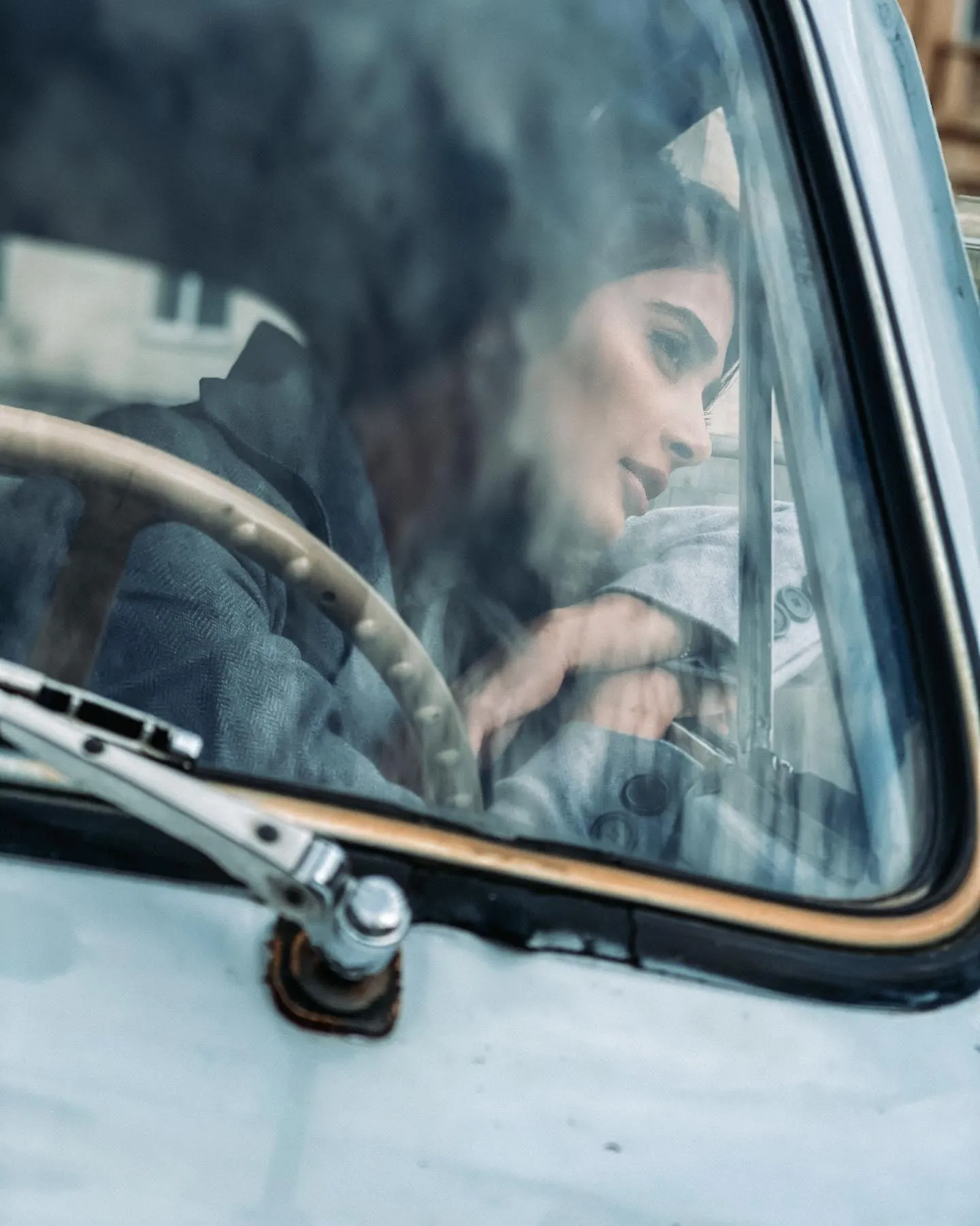 Pooja Hegde Looking Thoughtful Inside a Vintage Car