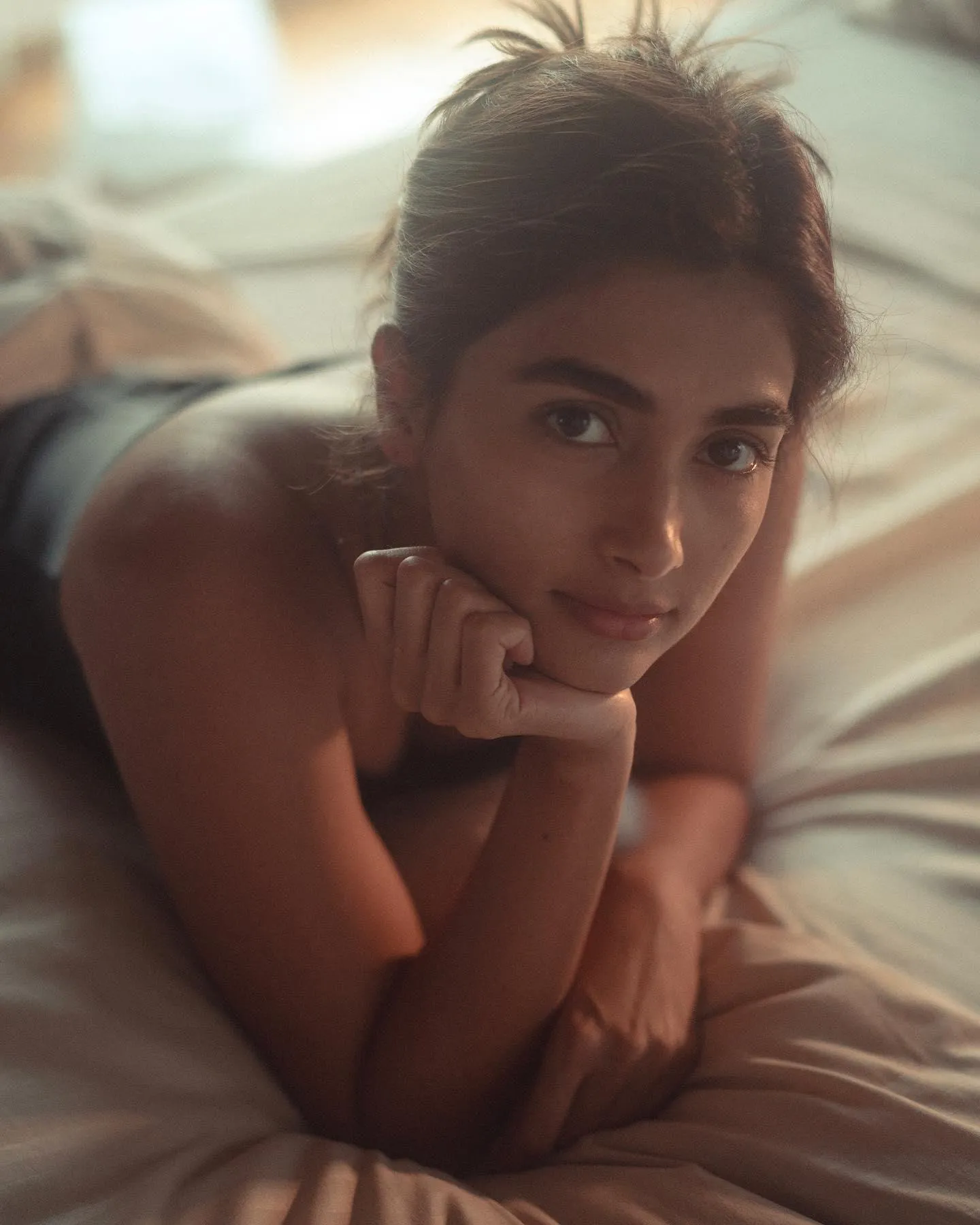 Pooja Hegde Lying Down Looking Softly Towards the Camera