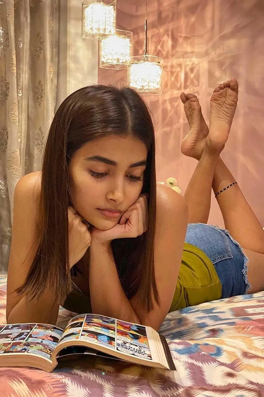 Pooja Hegde Lying on Bed Reading a Magazine Hd Image