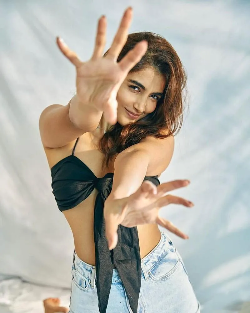 Pooja Hegde Playfully Posing in Beachwear with Open Arms