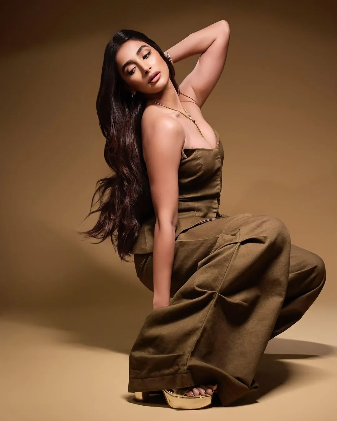 Pooja Hegde Poses Gracefully in a Strapless Brown Dress