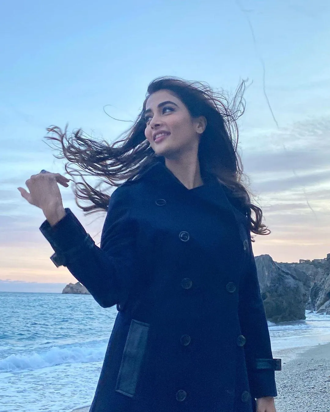 Pooja Hegde Posing By the Sea with Hair Blowing Image