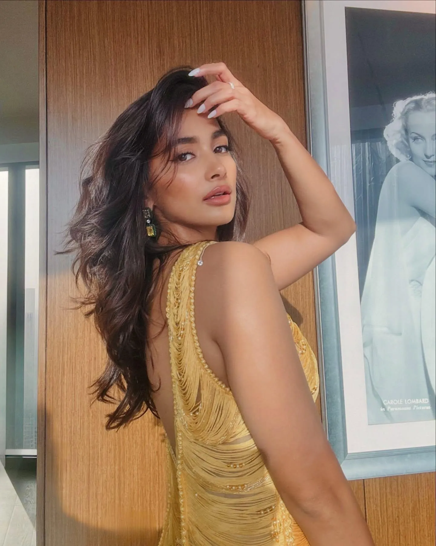Pooja Hegde Posing Indoors Wearing Golden Dress with Loose Hair